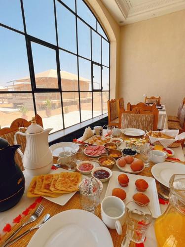 a table with plates of food on top of it at iMei Lux Camp 爱梅野奢营地 in Lac Yasmins