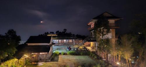 un edificio con piscina por la noche en Pumdikot Mountain Lodge, en Pokhara