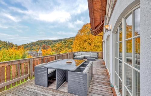a patio with a table and chairs on a deck at Nice Apartment In Südharz With Sauna in Stolberg i. Harz