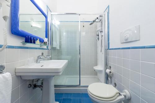 a bathroom with a sink and a toilet and a shower at Relais Regina Giovanna in Sorrento