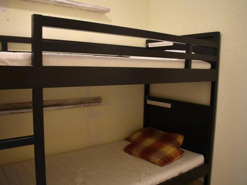 a bunk bed with a pillow on the bottom bunk at Studio Cabine Confortable - Proche Centre avec Parking - FR-1-580-31 in Font Romeu Odeillo Via