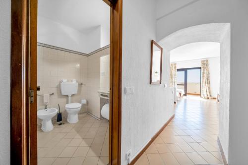 a bathroom with two toilets and a hallway at Bellavista Jardim By BeGuest in Albufeira