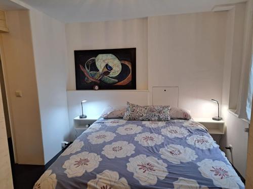 a bedroom with a bed and a painting on the wall at Bierfrauhäusl in Antdorf