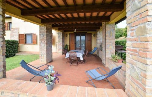 a patio with chairs and a table on a brick patio at Seranna 1 in Papiano
