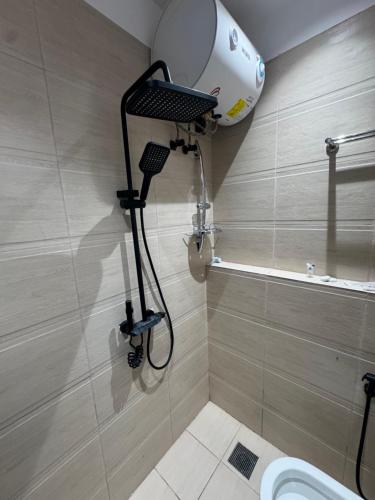 a shower in a bathroom with a toilet at شقق الفندقية للتأجير اليومي in Fulūj Sayghah
