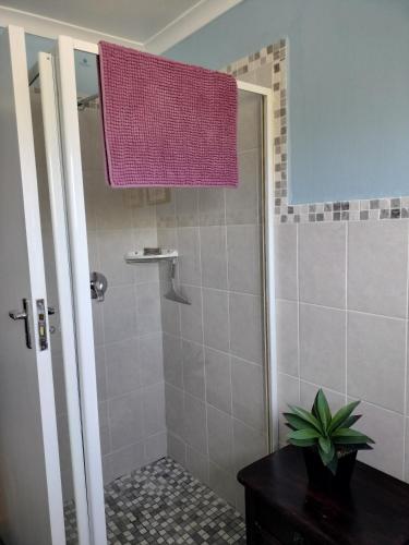 a bathroom with a shower with a purple shower curtain at Oz on M8re in Stanford
