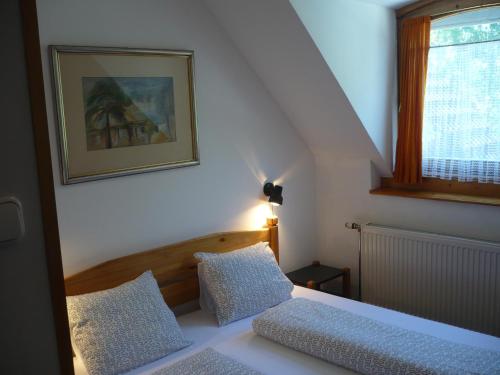 Un dormitorio pequeño con una cama y una ventana. en Keszi Panzió, en Budakeszi