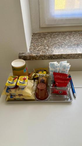 una bandeja con comida y otros artículos en un mostrador en Residenza Villaggio Frua, en Saronno