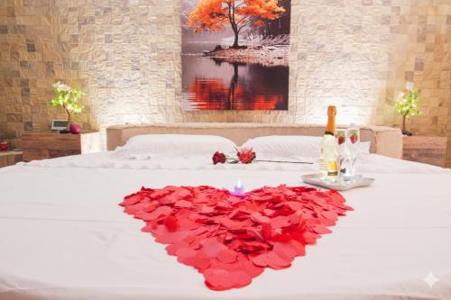 a bed with a heart made out of red roses at "Il Quercione" Room With SpA in Lama Di Peligni