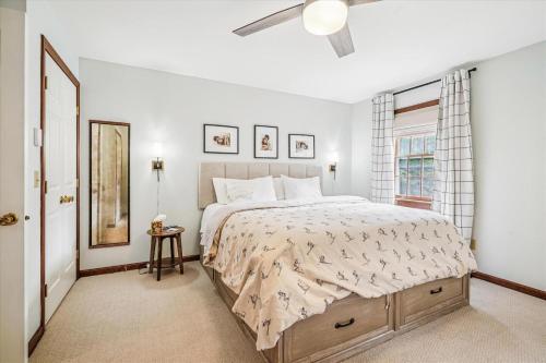 a bedroom with a large bed and a window at Fern and Fox Chalet in North Sherburne