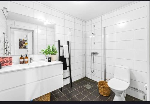 a white bathroom with a shower and a toilet at Dal Homestay Haven 4U in Dal