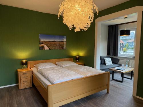 a bedroom with a bed and a green wall at Villa Gesine in Braunlage