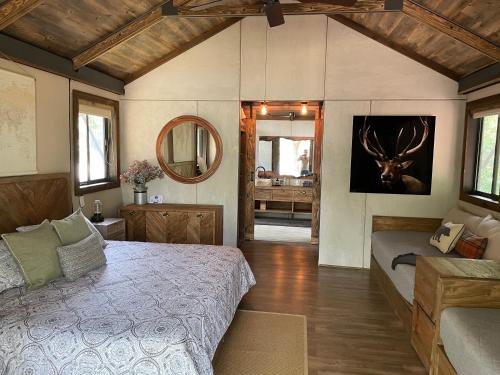a bedroom with a bed and a mirror at Premium Lakefront Cabin 1 The Armadillo in Bastrop