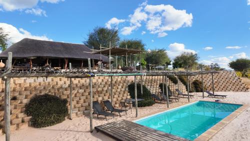 a resort with a swimming pool and a restaurant at Kazondwe Camp and Lodge in Kongola