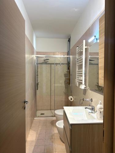 a bathroom with a shower and a toilet and a sink at Modern apartment - Salento Guest House in Monteroni di Lecce
