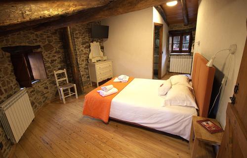 a bedroom with a large bed in a building at Casa do Talasnal Montanhas de Amor in Lousã
