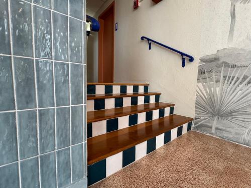 a staircase in a room with blue and white tiles at Blue Flamingo Suites in Miami Beach