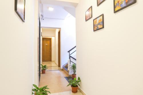 a hallway in a house with potted plants at FabHotel Saffron Inn I - Nr Darshan Museum in Pune