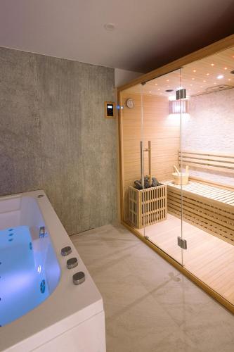 a large bathroom with a tub and a shower at Les Eclats d'Amour in Chargé
