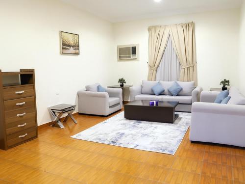 a living room with two couches and a table at المواسم in Tabuk