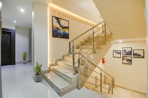 a staircase in a home with a metal railing at FabHotel Royal Palace II in Bhopal