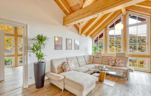 a living room with a couch and a table at Amazing Apartment In Südharz With Sauna in Stolberg i. Harz