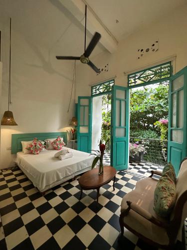 a bedroom with a bed and a checkered floor at Casa La Bella Samaria Boutique in Santa Marta