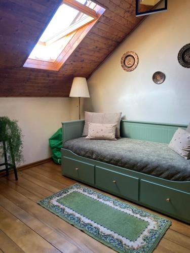 a bed in a room with a skylight at Grandma’s Cottage in Săcele
