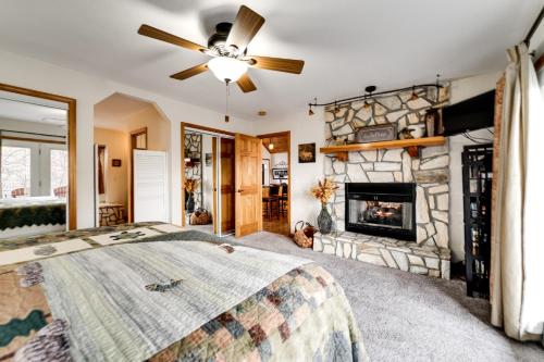 a bedroom with a fireplace and a ceiling fan at Dream Weaver in De Hart Mill