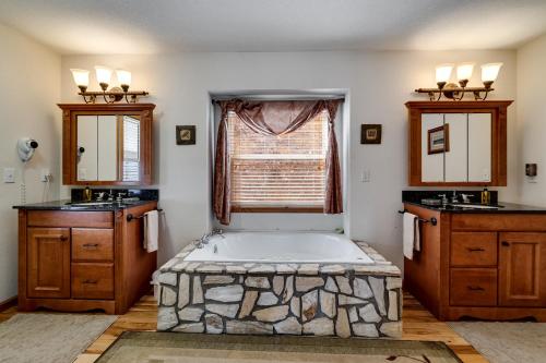 a bathroom with a large bath tub and a window at Dream Weaver in De Hart Mill