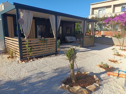 a house with a small tree in front of it at Villa Isabell - Camp Limoni 12 in Sukošan