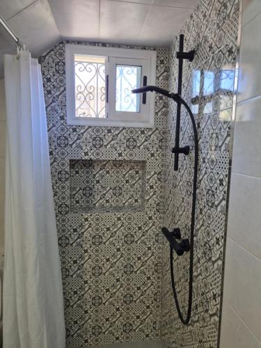 a shower in a bathroom with a window at House Timenziwin Tamraght in Tamraght Ouzdar