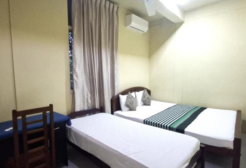 KalapaluwawaにあるNew Colombo Villageの窓のある小さな部屋にベッドが2つある