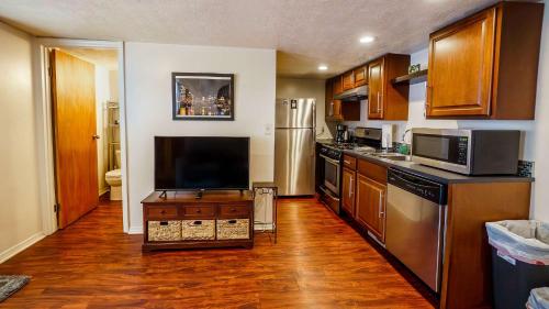 a kitchen with wooden floors and stainless steel appliances at 1 Bed Apt - Amazing Location 1 Block to Carson St in Pittsburgh