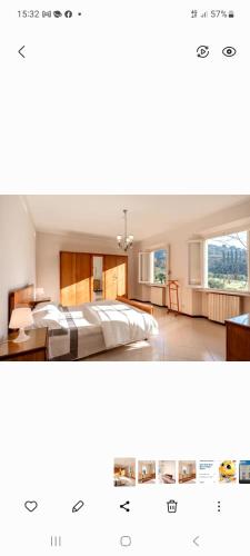 a bedroom with a bed and a room with windows at Villa BramaRosa in Montecatini Terme