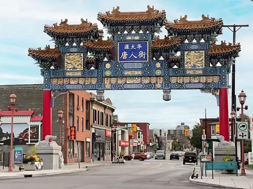 a large gate in the middle of a city street at King Bed Studio Apartment - Near Chinatown in Ottawa