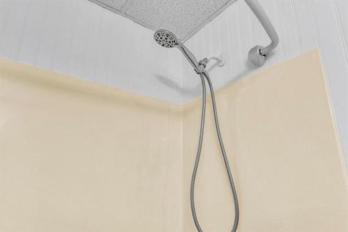a shower in a bathroom with a shower head at TruStay in Manchester in Manchester