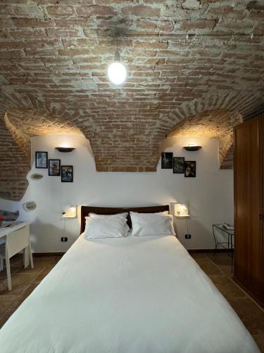 a bedroom with a large bed with a brick ceiling at Ca' D'Rosina in Narzole