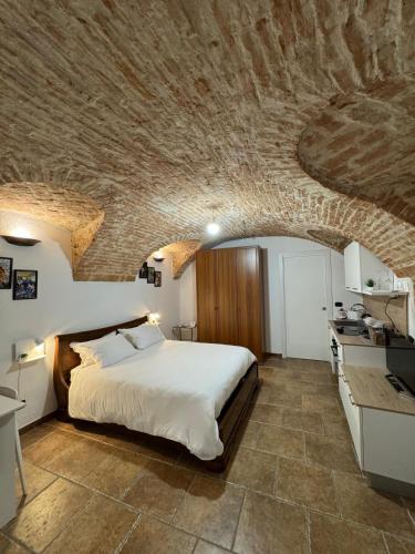a bedroom with a bed and a stone ceiling at Ca' D'Rosina in Narzole