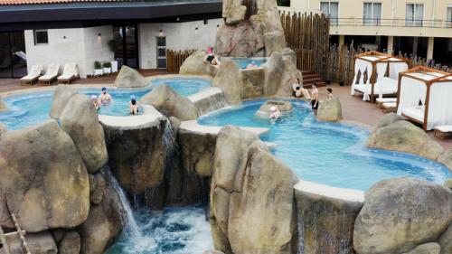a water slide in a resort with people in it at Elegant City House Moderno no Centro da Cidade in Chaves