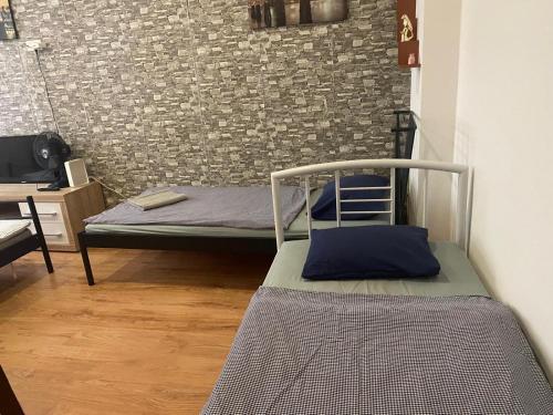 a bedroom with a bunk bed and a brick wall at Flat in Center Teplice in Teplice