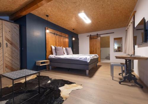 a bedroom with a bed and a blue wall at La Forge de Diogne - luxury and cosy B&B Alpine lodge in Crans-Montana