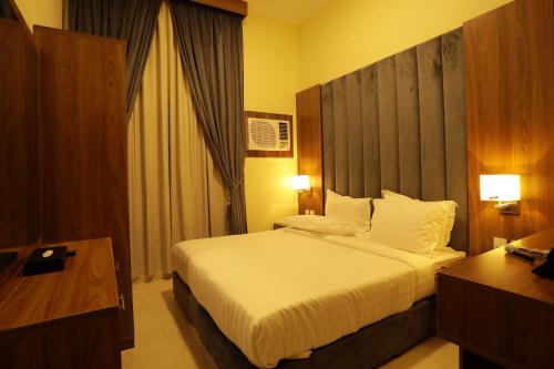 Ένα ή περισσότερα κρεβάτια σε δωμάτιο στο منازل الحساء للشقق الفندقية