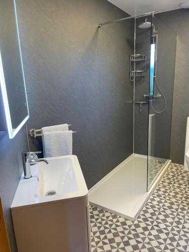 a bathroom with a sink and a shower at No 2 High Park Lodges in Orkney