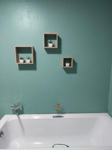a bathroom with a sink and three pictures on the wall at Sally's Place in Boksburg