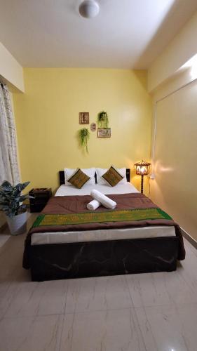 a bedroom with a large bed in a room at Mayabini Homestay 3BHK in Guwahati