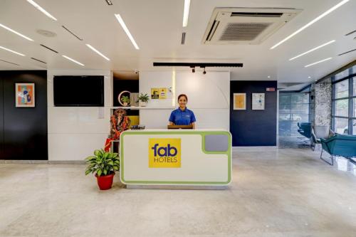a man standing behind a podium in an office at FabHotel Prime Oasis Blue - Near Chetak Bridge in Bhopal