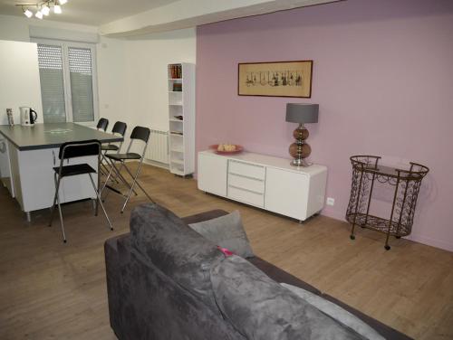 a living room with a couch and a table at Maison Authier in Périgueux