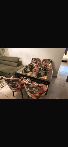 a living room with a table and a couch at Appartement a 10 min de l aeroport de marrakech in Marrakech