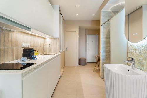 a bathroom with a sink and a bath tub at Nice Renting - HUGO - Luxury Honeymoon Suite Terrace Park View Free Parking in Nice
